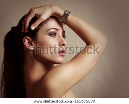 Sexy beautiful woman with modern watch on the hand. Color portrait