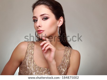 Fashion female model looking sexy with hand near face