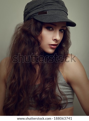 Trendy hiphop young woman in grey cap. Closeup vintage portrait