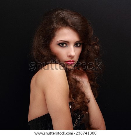 Sexy makeup woman with pink lipstick looking with light fear on black background