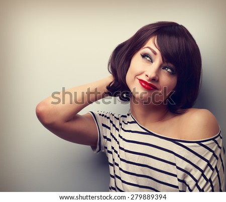 Beautiful short hair style thinking woman looking up on empty copy space. Vintage portrait