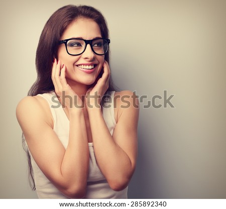 Happy laughing young casual woman holding hands the face. Vintage portrait with empty copy space