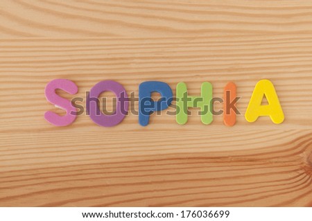 The female name Sophia made from foam letters on a wooden background