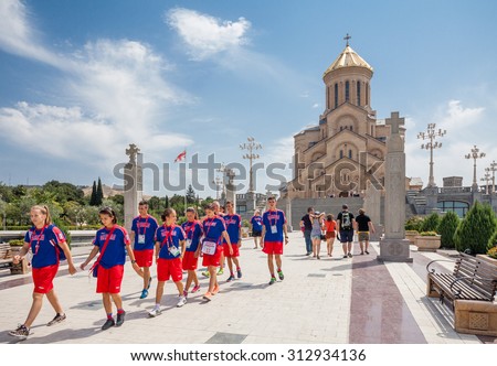 Tbilisi, Georgia - August 1, 2015: believers and tourists go to the Holy Trinity Cathedral of Tbilisi (Tsminda Sameba) - one of the largest Orthodox churches in the world.