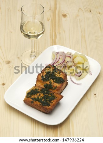 Salmon fish steak on white plate and white wine