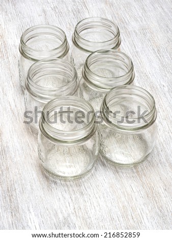 Empty jars on wooden background