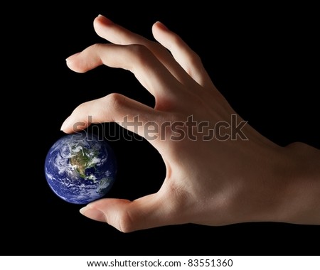 Hand holding little Earth as a symbol of power or responsibility. Earth globe image provided by NASA.