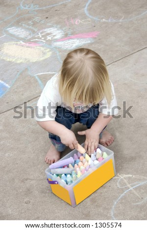 a little girl playing with sidewalk chalk