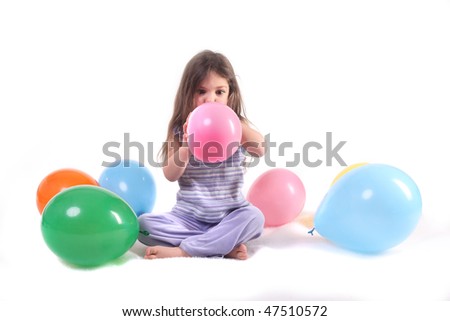 a little girl blowing up a balloon surrounded by balloons