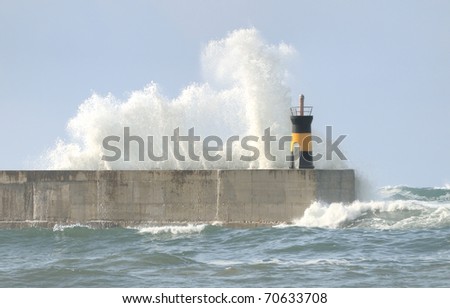 Breaking wave on lighthouse wall