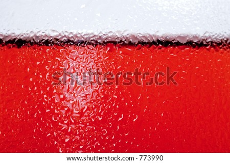 Extreme close up of side of glass with rose wine in it with chilled water droplets on the side