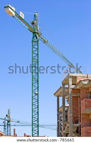 Typical sunny Spanish building site on the Costa del Sol with half built property and cranes
