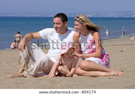 Young attractive family on beach vacation in Spain on the Costa del Sol on a sunny day