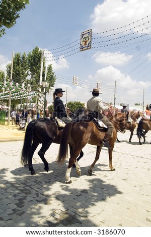 Riders taking a walk by the fair of Seville