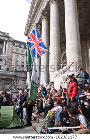 LONDON, UK-MAY 12: Protesters with banners from the Occupy movement set up camp outside the Royal Exchange, near to the Bank of England in an international day of action. May 12, 2012 in London UK