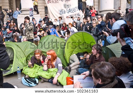 LONDON, UK-MAY 12: Protesters with banners from the Occupy movement set up camp outside the Royal Exchange, near to the Bank of England in an international day of action. May 12, 2012 in London UK