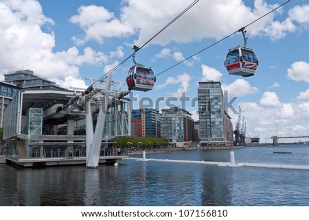 LONDON, UK-JUNE 30:Visitors travel on Emirates Air Line cable cars. The service is the UK's first urban cable car running across the Thames from the O2 to the Excel centre  June 30, 2012 in London UK