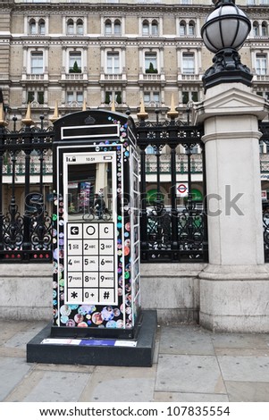 LONDON,UK-JULY 15: Designer Fred Butler\'s Mobile Phone design for  BT Art Box, an art installation and charity fundraiser using the iconic red phone box design. July 15, 2012 in London UK