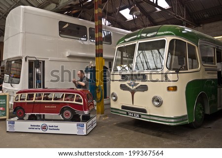 FAVERSHAM, UK-MAY 17: Visitors enjoy the South East Coach Works displays and models, part of the Transport weekend that attracts thousands of visitors each year. May 17, 2014 in Faversham UK.