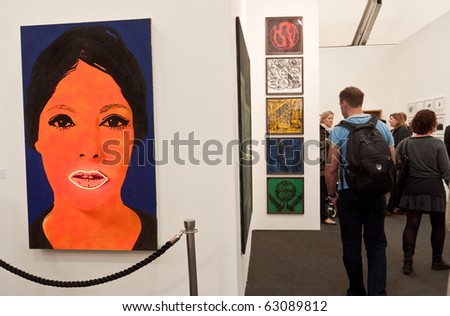 LONDON, UK - OCTOBER 14: Collectors and Visitors Looking at Art on Georg Kargl\'s stand at Frieze, the Annual International Contemporary  Art Fair in Regents Park London, October, 14 2010