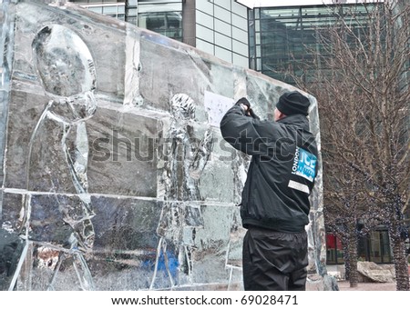 LONDON, UK- JANUARY 15: A unidentified member of the Hungarian Ice Sculpting Team at work in the Annual London Ice Sculpting Festival, on January 15, 2011 in London, UK