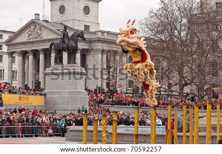 LONDON, UK-FEBRUARY 6: Acrobatic Lion Dancers leap across the poles in Trafalgar Square, during the famous Chinese New Year Celebrations. February 6,2011 in London, UK.