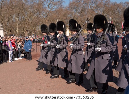 LONDON, UK - MARCH 19: Members of the company of the Grenadier Guards Marching into Buckingham Palace during the Changing of the Guard Ceremony. March 19, 2011 in London UK.