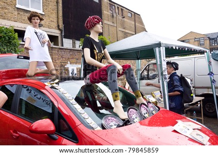 LONDON, UK- JUNE 19: Iconic Fashion Designer, musician and artist Pam Hogg\'s stall with car and Mannequins at the Annual Art Car Boot Fair in London\'s East End on June 19, 2011 in London UK.