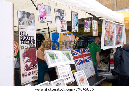 LONDON, UK- JUNE 19: Artist Swifty shows prints and art work on his stall at the Annual Art Car Boot Fair in London\'s East End on June 19, 2011 in London UK.