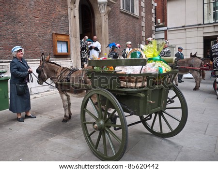 LONDON, UK-SEPTEMBER 25: Local residents participate in the Old English custom of the Pearly Kings and Queens delivering harvest festival offerings from their donkey carts to St Mary-le Bow Church on September 25, 2011 in London, UK.