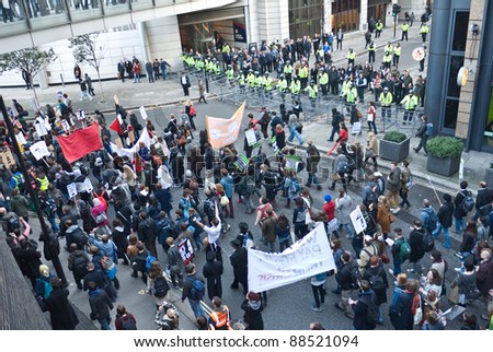 LONDON, UK-NOVEMBER 9: Student demonstrators carrying banners protest against fee increases, march past police manning barriers to stop them from entering the Stock Exchange on November 9, 2011 in London UK