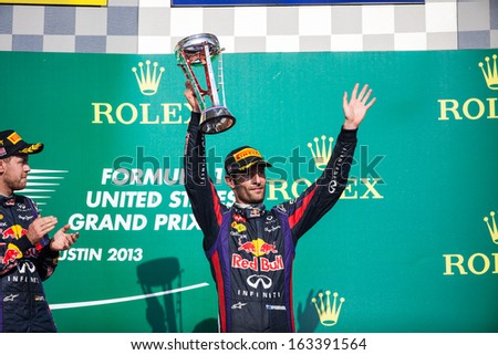AUSTIN, TEXAS - NOVEMBER 17.  Mark Webber holding up his third place trophy on the podeum after the Formula 1 United States Grand Prix on November 17, 2013 in Austin, Texas.
