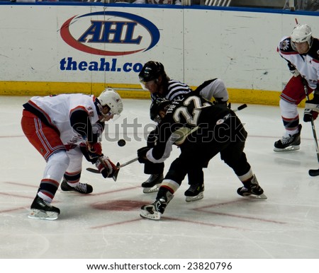 HARTFORD, CONNECTICUT, JANUARY 24, 2009:  Patrick Rissmiller of the Wolf Pack faces off Jeff Taffe of the Penguins during a game at the Hartford XL Center on January 24, 2009 in Hartford, CT.