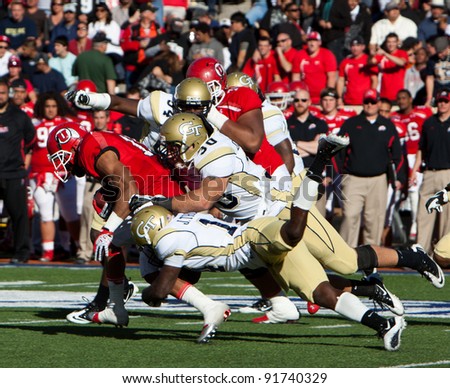 EL PASO – DECEMBER 31:  UTAH\'s John White IV (15) being gang tackled during UTAH\'s overtime 30 to 27 win over Georgia Tech at the Sun Bowl on December 31, 2011 in El Paso, Texas.