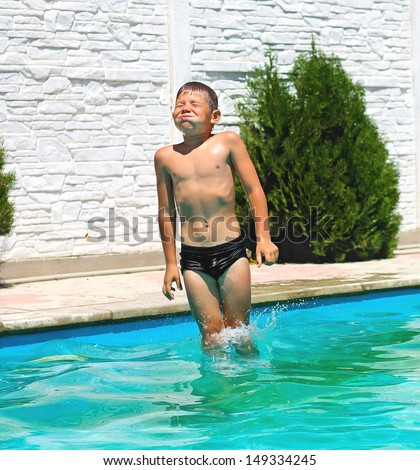 Funny boy are jumping to the swimming pool