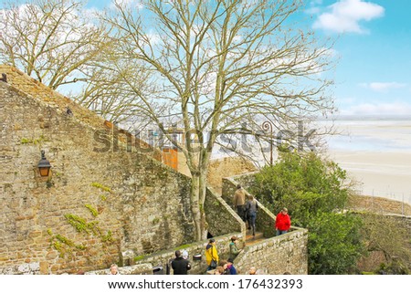 LE MONT SAINT MICHEL,FRANCE - DECEMBER 28, 2012 : Tourists in the abbey  in Mont Saint Michel. Normandy, France