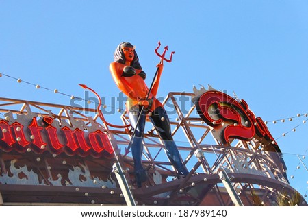 LAS VEGAS, NEVADA, USA - OCTOBER 21, 2013 : A devil girl statue stands on the top of Diablo\'s Cantina in front of the Monte Carlo in Las Vegas