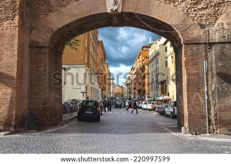 ROME, ITALY - MAY 03, 2014: People on street Via del Mascherino in Rome. Gate in the wall, enclosing Vatican City
