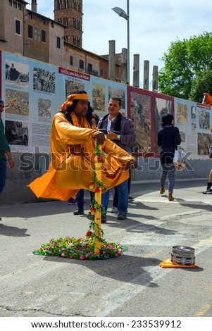 ROME, ITALY - MAY 04, 2014: Street performer in clothing monk demonstrates  trick of levitation in Rome, Italy