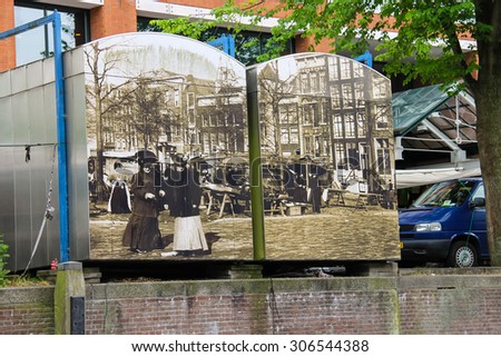 Amsterdam, Netherlands - June 20, 2015: Trade booths on the market Waterlooplein decorated historical photos. Amsterdam