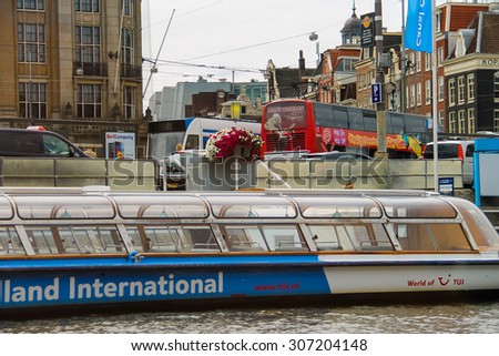 Amsterdam, Netherlands - June 20, 2015: Excursion ships are near the pier on the waterfront in Amsterdam