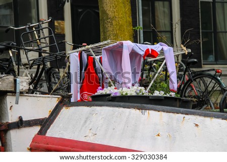 Amsterdam, Netherlands - June 20, 2015: Clothes drying on board a ship on the canal in Amsterdam
