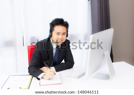 smiling business man working with desktop computer