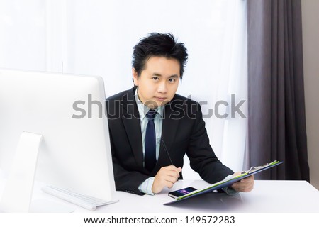 business man working with smart phone and desktop computer