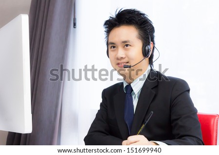 smiling business man working with desktop computer