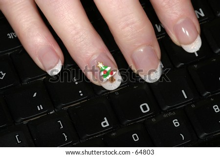 A festive fingernail painting, ready for Christmas, on a laptop keyboard