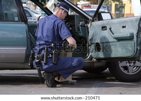 Australian Police officer at work on a stolen car...