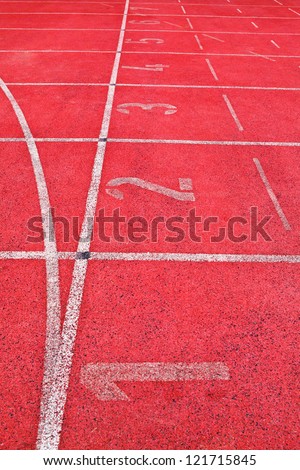 red running track field with white lines