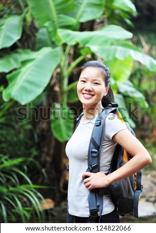 young woman hiking at tropical jungle