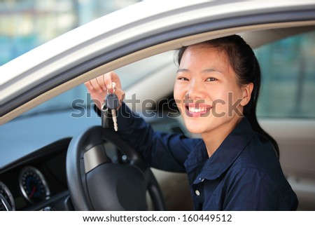 happy woman driver in her first car